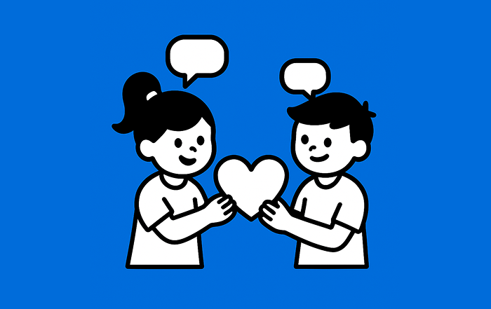 Dos estudiantes dialogan mientras sostienen un corazón, representando la educación para la sexualidad y la construcción de ciudadanía.